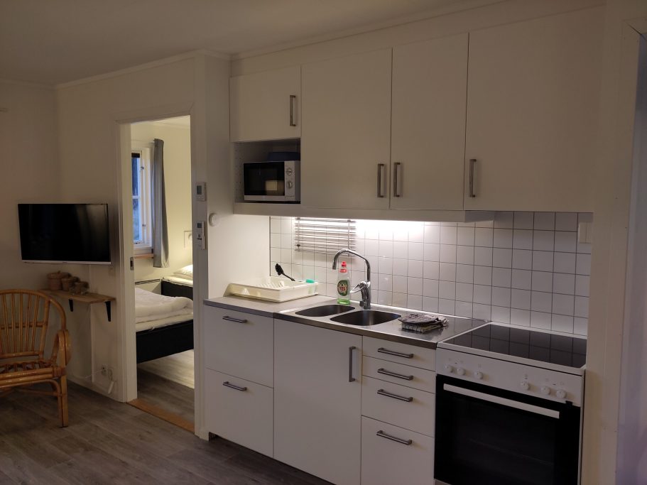 Kök Ljus och modern köksmiljö med vit inredning och elektriska apparater.